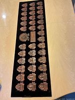 Full view of rectangular plaque showing all presidential medallions on black background