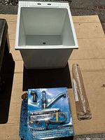 Sink, packaged faucet, legs in cardboard tube