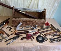 Group shot of toolbox and assorted tools spread on table