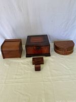 Group shot of four wooden boxes and stamp dispenser