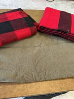 All three folded wool blankets displayed