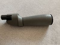 Side view of the telescope showing the body, eyepiece, and focus adjustment knob.