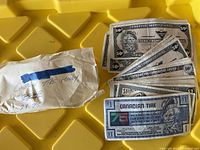 Canadian Tire money bills in various denominations with a handwritten envelope, showing wear and age.