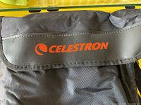 Close-up photo of the Celestron logo on the carrying case flap.