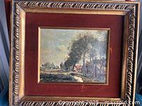 Framed oil painting showing the full artwork and frame in natural lighting, highlighting wear on the frame.