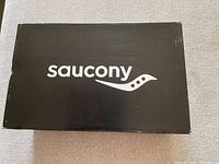 Closed black Saucony box with brand logo on lid.
