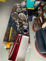 Overview of assorted plated items including serving pieces and Gerber Legendary Blades carving set boxed