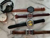 Overhead view of all seven watches arranged in a row