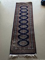 Full view of the wool rug runner showing overall geometric design and length.