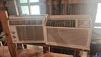 Two Danby window air conditioners side by side on shelf