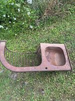 Top view of entire metal feeding trough showing bowl and bar rack