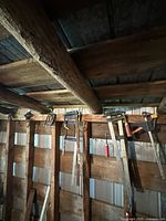 Row of assorted clamps hanging on wall stud