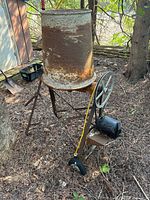 Full view of cement mixer on stand in outdoor setting