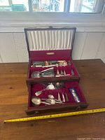 Open flatware chest showing both tiers and contents