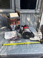 Router with manuals, box and wrench displayed on table