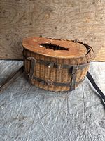 Full view of wicker creel with wood lid and leather straps