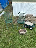 Full lot view: two green metal chairs, Step2 garden caddy, oval planter on grass