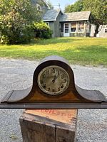 Front view of complete wooden tambour mantle clock with dial visible