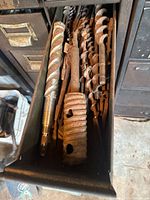 Drawer containing multiple large spiral and auger drill bits