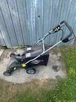 Full view of LawnVac from side showing handle and bag