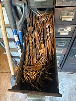 Drawer filled with large and small drill bits