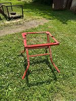 Overall view of red metal work stand on grass