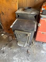 Three-quarter front view of stove showing overall design and wear