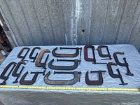 All C-clamps laid out beside tape for scale