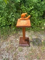 Full view of wooden pedestal ashtray stand with carved beaver on top