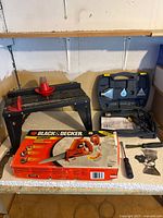 Overall lot showing boxed handsaw, work stand, heat tool kit, screwdriver, metal bracket