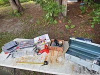 Overall view of table with toolbox, power tools, organizers and accessories