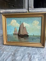 Front view of framed sailboat oil painting