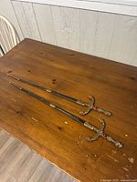 Both swords full length on tabletop