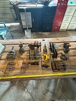 Overall view of vises and clamps laid out on workbench