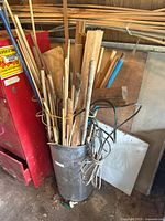 Container filled with assorted wooden dowels and trim pieces of varying sizes