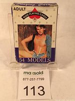 Front of playing card box showing a nude male model wearing denim jacket, labeled 'ADULT NUDE PLAYING CARDS 54 MODELS'. Box shows wear on edges.