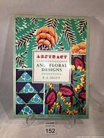 Front cover of the book showing title 'Abstract and Floral Designs' by E.A. Séguy with colorful Art Nouveau style patterns of abstract leaves and flowers.