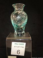 Clear glass Caithness Flamenco range vase on a display block showing full front with label.