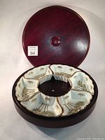 Wooden Lazy Susan base with porcelain dishes removed showing round platform and base detail.