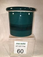 Front and side view of green glazed stoneware butter dish showing glossy surface and fitted lid