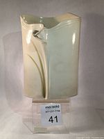Front view of the Gary Merkel porcelain vase showing three-dimensional lily design and soft pastel color gradations.