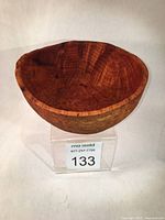 Front view of wooden bowl showing interior grain and natural color variations.