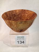 Close-up photo of the birdseye maple bowl showing the grain and twisted wood patterns from the front angle.