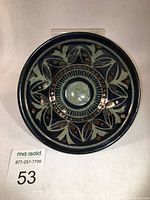 Top view of Meg Burgess stoneware bowl showing intricate cobalt oxide wax resist floral pattern under celadon glaze