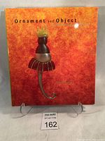 Front cover of the book showing the colorful artistic cover featuring a sculptural figure with warm orange background