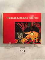 Front cover of the paperback book titled 'Picasso Linocuts 1958-1963' with red background and abstract colored print.