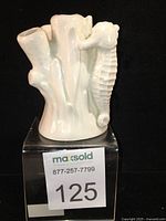 Front view of the porcelain seahorse and coral flower frog flower vase with item lot number tag visible.