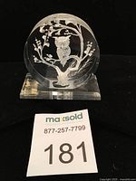Front view of the vintage lucite owl sculpture on a flat lucite base with the owl perched in a tree.
