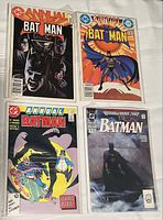 Four Batman annual comics arranged in two rows of two in protective sleeves on a white surface.
