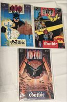 Photo of three Batman Legends of the Dark Knight comics, issues 6, 7, and 8, laid out on a white surface, showing full front covers each in protective sleeves.